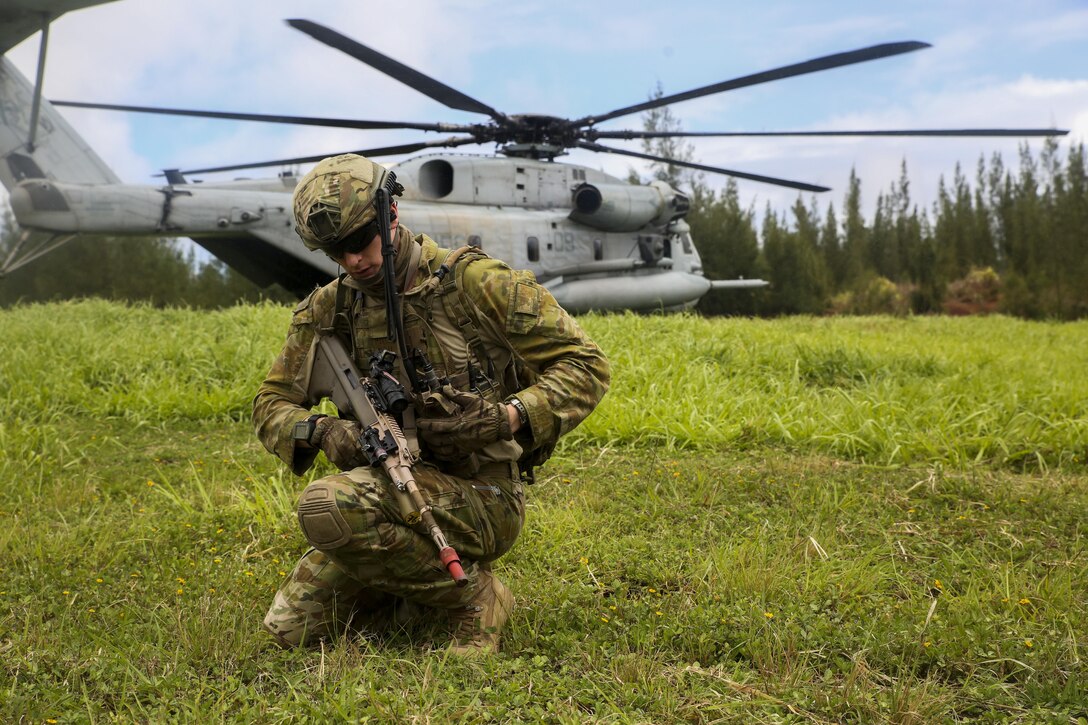A member of the Australian Army, attached to Golf Company, 2nd Battalion, 3rd Marines, establishes communication after debarking a CH53E Super Stallion helicopter during  Rim of the Pacific 2016.  Twenty-six nations, 49 ships, six submarines, about 200 aircraft, and 25,000 personnel are participating in RIMPAC 16 from June 29 to Aug. 4 in and around the Hawaiian Islands and Southern California. The world’s largest international maritime exercise, RIMPAC provides a unique training opportunity while fostering and sustaining cooperative relationships between participants critical to ensuring the safety of sea lanes and security on the world’s oceans. 