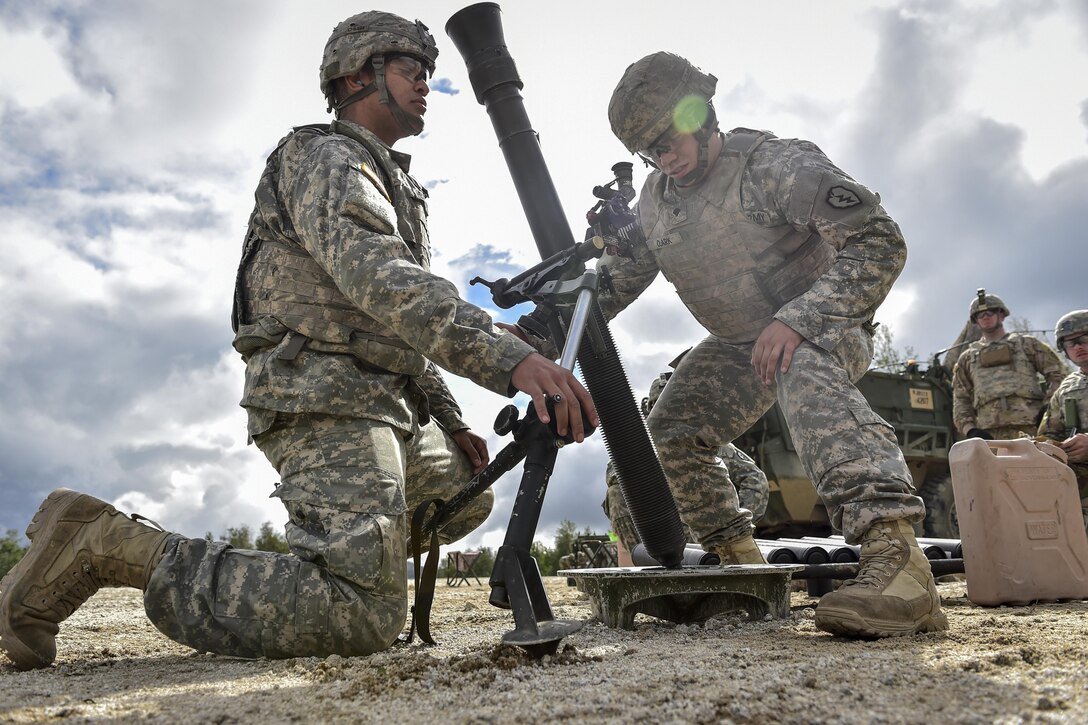 Army Pfc. Camill Hernandez, left, and Spc. Caleb Clark prepare to fire an 81mm mortar during Arctic Anvil 2016 at the Yukon Training Area near Fort Wainwright, Alaska, July 23, 2016. The multinational exercise aims to improve interoperability. Hernandez and Clark are assigned to the 25th Infantry Division's 1st Stryker Brigade Combat Team. Air Force photo by Justin Connaher

