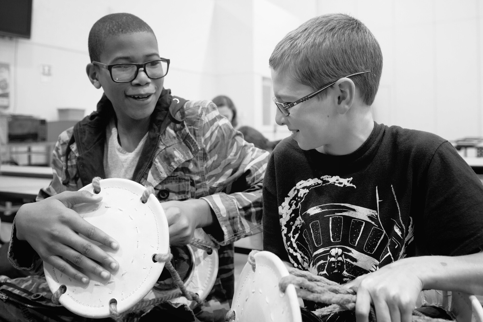 Children practice using their tszumi drum during a workshop at the middle school of Yokota Air Base, Japan, July 18, 2016. Tsuzumi Do Group members volunteered their time to come out and share in a cultural exchange through music with Yokota Middle School children and their families. (U.S. Air Force photo by Senior Airman Delano Scott/Released)