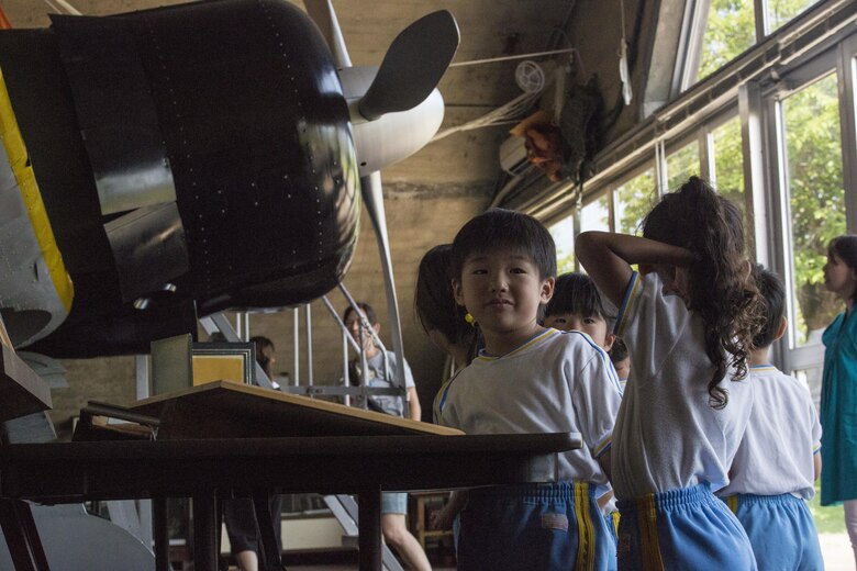 Students of Iwakuni-Kawashimo Kindergarten explore the base zero hangar during a school visit at Marine Corps Air Station Iwakuni, Japan, July 21, 2016. The school visit is a time honored tradition between the base and the local community and holds a lasting memory with the visiting students. (U.S. Marine Corps photo by Cpl. Nathan Wicks)