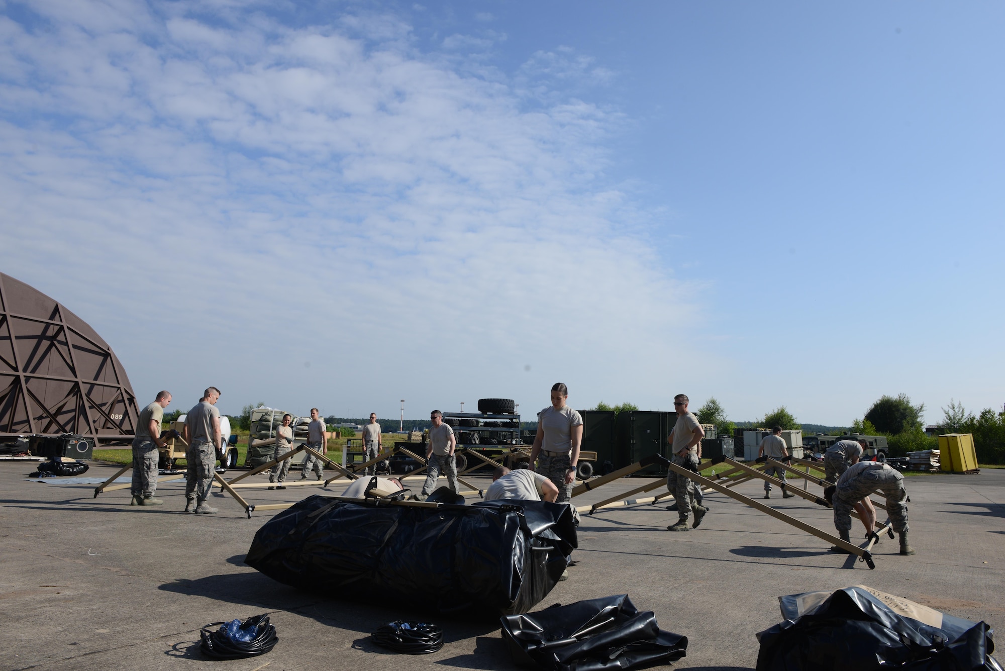 Airmen with the 435th Contingency Response Group learn how to use newly acquired Tent Model 60 tents at Ramstein Air Base, Germany, July 18, 2016. The 435th CRG sought tents which would be durable and quick to set up as they respond to missions around the world. (U.S. Air Force photo/ Airman 1st Class Joshua Magbanua) 