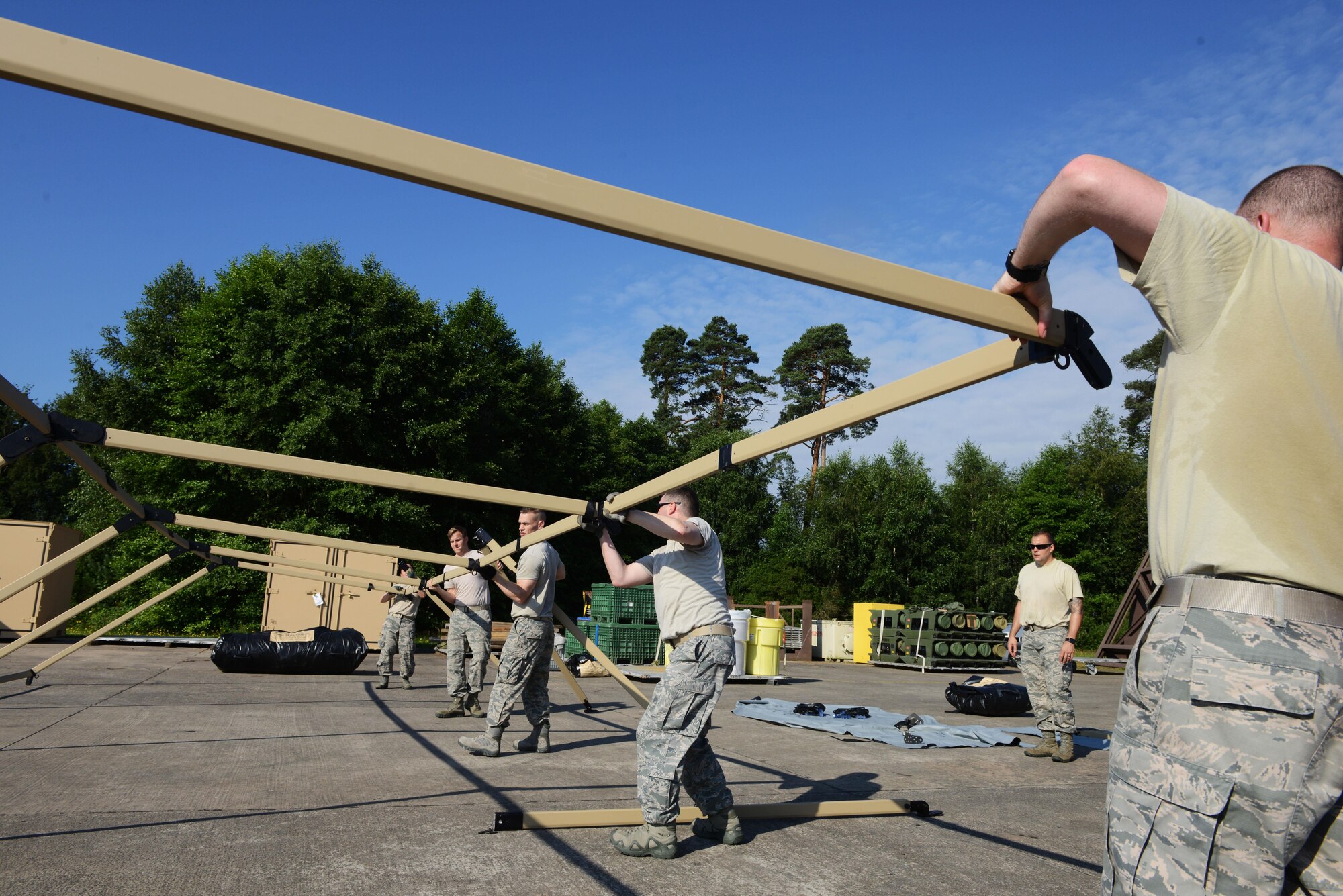 435th Contingency Response Group Airmen assemble the frame of a Tent Model 60 tent at Ramstein Air Base, Germany, July 18, 2016. The newly acquired tents are designed to be more durable than the previous tent models the 435th CRG previously used. (U.S. Air Force photo/ Airman 1st Class Joshua Magbanua)