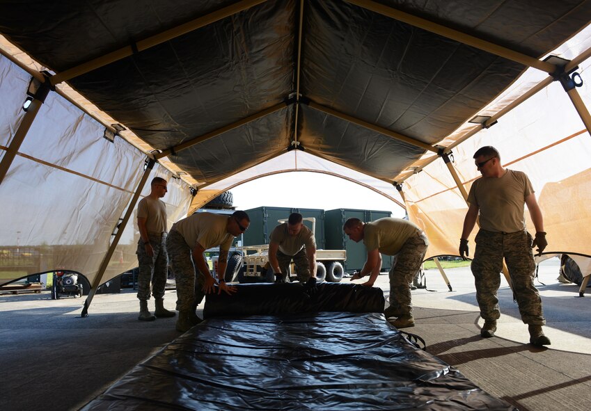 435th Contingency Response Group Airmen take down a Tent Model 60 tent during training at Ramstein Air Base, Germany, July 18, 2016. The Airmen repeated the process of assembling and disassembling the tent several times in order to familiarize themselves with the new system. (U.S. Air Force photo/ Airman 1st Class Joshua Magbanua)