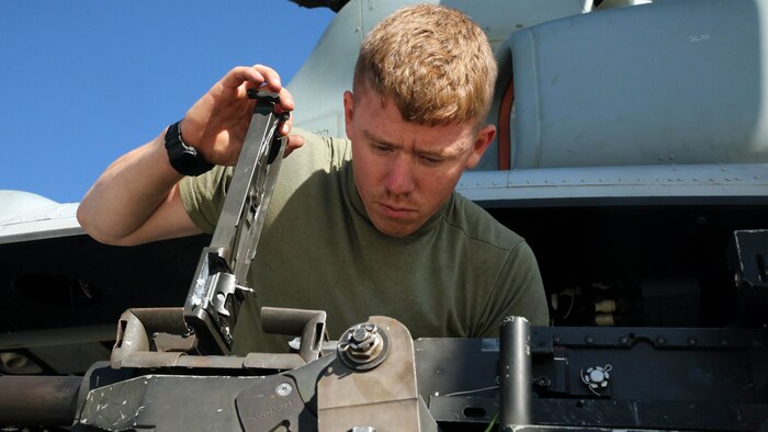 Cpl. Christopher Neumann inspects a GAU-21 .50 caliber machine gun before a close air support exercise at Pohakuloa Training Area, Hawaii, July 19, 2016. Neumann is participating in Rim of the Pacific 2016, a multinational military exercise, from June 29 to Aug. 8 in and around the Hawaiian Islands. RIMPAC offers the U.S. military the opportunity to train with partners and allies in the Pacific region. Neumann, a native of Wells, Maine, is a UH-1Y Huey crew chief with Marine Light Attack Helicopter Squadron 367, which supports III Marine Expeditionary Force. 