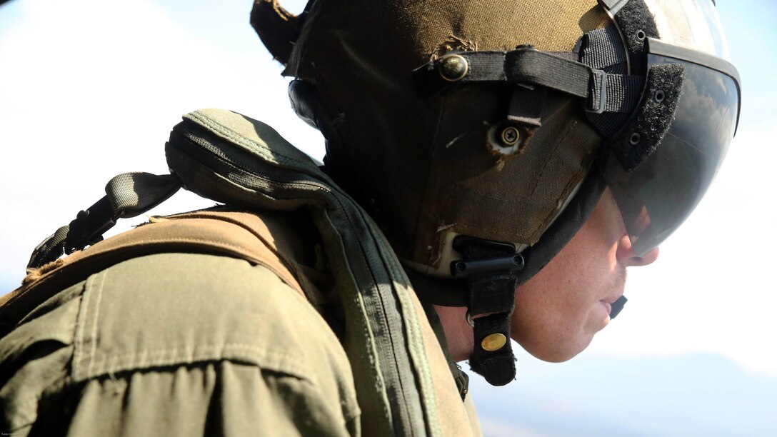 Cpl. Christopher Neumann looks at the terrain during a close air support exercise over Pohakuloa Training Area, Hawaii, July 19, 2016. Neumann is participating in Rim of the Pacific 2016, a multinational military exercise, from June 29 to Aug. 8 in and around the Hawaiian Islands. RIMPAC offers the U.S. military the opportunity to train with partners and allies in the Pacific region. Neumann, a native of Wells, Maine, is a UH-1Y Huey crew chief with Marine Light Attack Helicopter Squadron 367, which supports III Marine Expeditionary Force. 