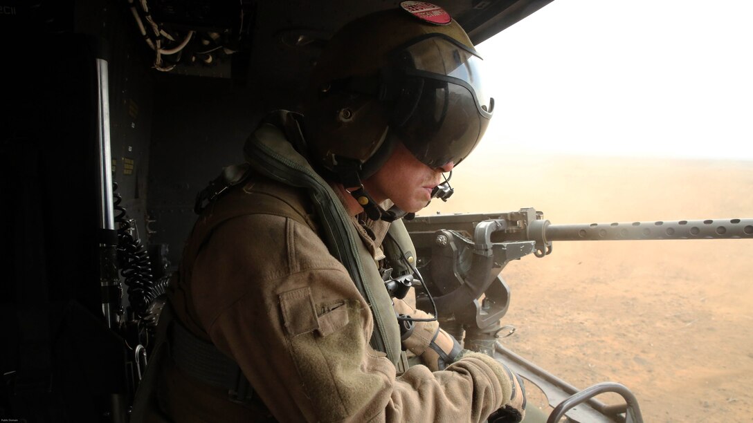 Cpl. Christopher Neumann relays distance-to-ground information to UH-1Y pilots during a close air support exercise at Pohakuloa Training Area, Hawaii, July 19, 2016. Neumann is participating in Rim of the Pacific 2016, a multinational military exercise, from June 29 to Aug. 8 in and around the Hawaiian Islands. RIMPAC offers the U.S. military the opportunity to train with partners and allies in the Pacific region. Neumann, a native of Wells, Maine, is a UH-1Y Huey crew chief with Marine Light Attack Helicopter Squadron 367, which supports III Marine Expeditionary Force. 