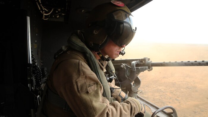 Cpl. Christopher Neumann relays distance-to-ground information to UH-1Y pilots during a close air support exercise at Pohakuloa Training Area, Hawaii, July 19, 2016. Neumann is participating in Rim of the Pacific 2016, a multinational military exercise, from June 29 to Aug. 8 in and around the Hawaiian Islands. RIMPAC offers the U.S. military the opportunity to train with partners and allies in the Pacific region. Neumann, a native of Wells, Maine, is a UH-1Y Huey crew chief with Marine Light Attack Helicopter Squadron 367, which supports III Marine Expeditionary Force. 
