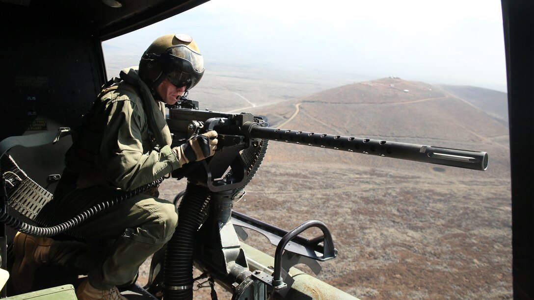 Cpl. Christopher Neumann aims his GAU-21 .50 caliber machine gun during a close air support exercise at Pohakuloa Training Area, Hawaii, July 19, 2016. Neumann is participating in Rim of the Pacific 2016, a multinational military exercise, from June 29 to Aug. 8 in and around the Hawaiian Islands. RIMPAC offers the U.S. military the opportunity to train with partners and allies in the Pacific region. Neumann, a native of Wells, Maine, is a UH-1Y Huey crew chief with Marine Light Attack Helicopter 367, which supports III Marine Expeditionary Force. 
