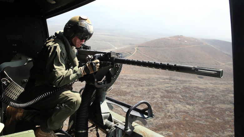 Cpl. Christopher Neumann aims his GAU-21 .50 caliber machine gun during a close air support exercise at Pohakuloa Training Area, Hawaii, July 19, 2016. Neumann is participating in Rim of the Pacific 2016, a multinational military exercise, from June 29 to Aug. 8 in and around the Hawaiian Islands. RIMPAC offers the U.S. military the opportunity to train with partners and allies in the Pacific region. Neumann, a native of Wells, Maine, is a UH-1Y Huey crew chief with Marine Light Attack Helicopter 367, which supports III Marine Expeditionary Force. 