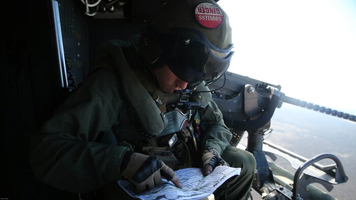 Cpl. Christopher Neumann reviews his objectives during a close air support exercise at Pohakuloa Training Area, Hawaii, July 19, 2016. Neumann is participating in Rim of the Pacific 2016, a multinational military exercise, from June 29 to Aug. 8 in and around the Hawaiian Islands. RIMPAC offers the U.S. military the opportunity to train with partners and allies in the Pacific region. Neumann, a native of Wells, Maine, is a UH-1Y Huey crew chief with Marine Light Attack Helicopter Squadron 367, which supports III Marine Expeditionary Force. 