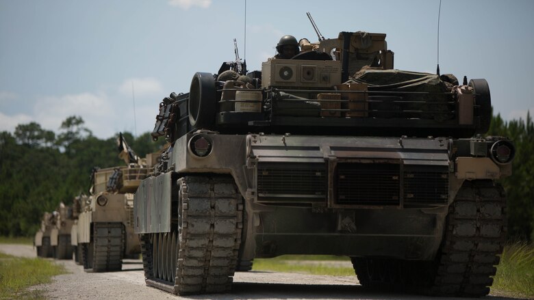 Marines with Fox Company, 4th Tank Battalion, stop at a landing zone to assess locations for an upcoming offensive and defensive drill at Marine Corps Base Camp Lejeune, N.C., July 19, 2016. The exercise brought the reserve Marines together with elements of 2nd Tank Bn. to train in the event they deploy as one battalion in the future. 