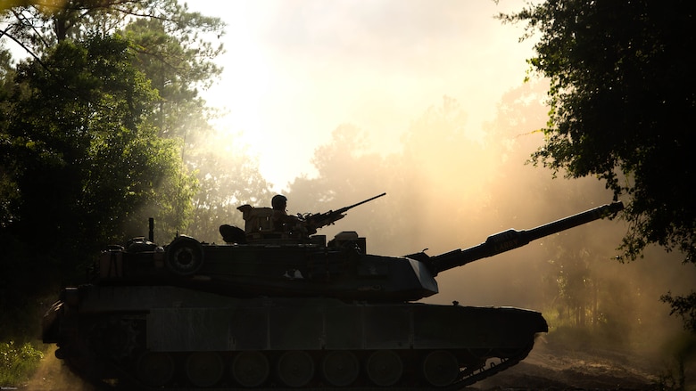 An M1A1 Abrams with Fox Company, 4th Tank Battalion, drives down a dirt road to leave Engineer Training Area 2 on Marine Corps Base Camp Lejeune, N.C., July 21, 2016. The intent was to bring the active and reserve Marines together to train in the event they deploy as one battalion in the future. 