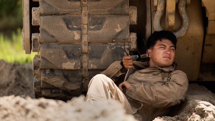 Lance Cpl. Hugo Orozco, an M88A2 Hercules tank mechanic with Fox Company, 4th Tank Battalion, rests under the shade of his vehicle at Engineer Training Area 2 during a training exercise on Marine Corps Base Camp Lejeune, N.C., July 21, 2016. The intent was to bring the active and reserve Marines together to train in the event they deploy as one battalion in the future.