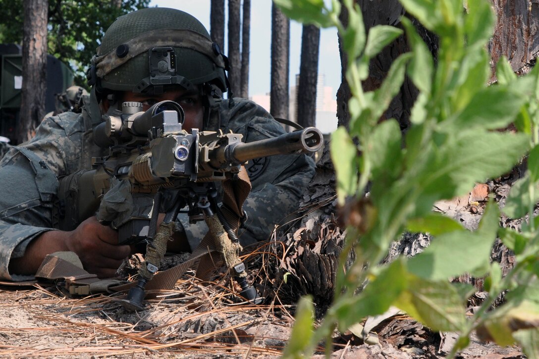 Army Sgt. Alexis Bruno provides security for his platoon during training at the Joint Readiness Training Center, Fort Polk, La., July 25, 2016. Bruno is a sniper assigned to New York National Guard's Headquarters Company, 1st Battalion, 69th Infantry Regiment. About 5,000 Army National Guard, active Army and Army Reserve troops are honing their skills and practicing integrating combat operations as part of the 27th Infantry Brigade Combat Team task force. Army National Guard photo by Sgt. Maj. Corine Lombardo

