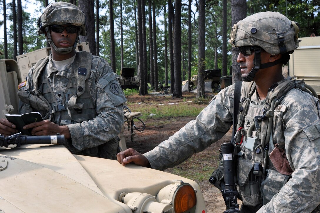 Army Staff Sgt. Irshaad Mohamed, right, discusses mission requirements with Spc. Trazile Marckensom at the Joint Readiness Training Center in Fort Polk, La., July 25, 2016. Mohamed is an infantryman and section leader assigned to the New York Army National Guard's Company D, 1st Battalion, 69th Infantry Regiment. Army National Guard photo by Sgt. Maj. Corine Lombardo
