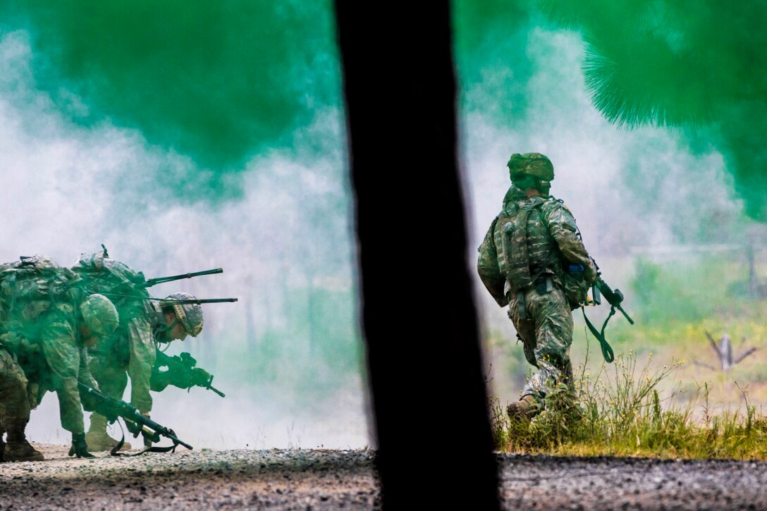 Soldiers advance through a smoke screen during live-fire training at the Joint Readiness Training Center in Fort Polk, La., July 25, 2016. The soldiers are assigned to the New York Army National Guard's Company C, 1st Battalion, 69th Infantry Regiment. Army National Guard photo by Sgt. Harley Jelis