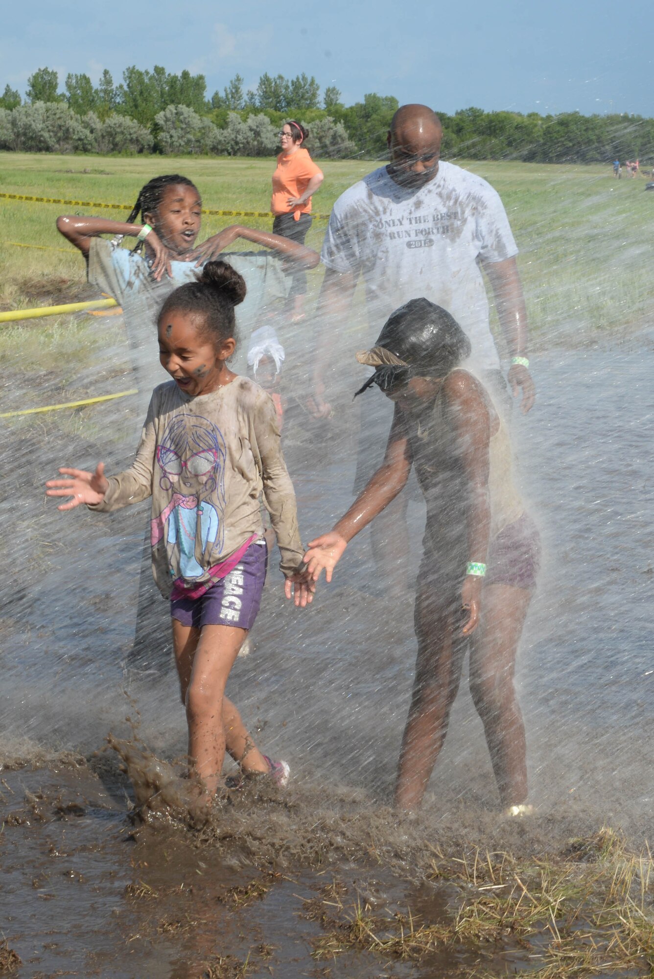The 5th Force Support Squadron hosted the 2016 Mini Mudder at Minot Air Force Base, N.D., July 15, 2016. The race consisted of different obstacles that challenged Airmen and their families to crawl, climb, run and slide through mud and water. Approximately 900 Airmen and their families attend the event, which lasted 2 hours. (U.S. Air Force photo/Airman 1st Class Jessica Weissman) 
