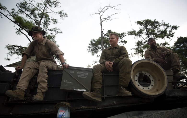 Marines with Fox Company, 4th Tank Battalion, sit atop their M1A1 Abrams battle tank and laugh at the idea of getting their photo taken during a training exercise on Camp Lejeune, July 19, 2016. The exercise brought the reserve Marines together with elements of 2nd Tank Bn. to train in the event they deploy as one battalion in the future. (U.S. Marine Corps photo by Sgt. Matthew Callahan)