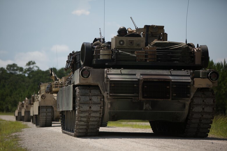 Marines with Fox Company, 4th Tank Battalion, stop at a landing zone to assess locations for an upcoming offensive and defensive drill at Camp Lejeune, N.C., July 19, 2016. The exercise brought the reserve Marines together with elements of 2nd Tank Bn. to train in the event they deploy as one battalion in the future. (U.S. Marine Corps photo by  Pfc. Juan Soto-Delgado)