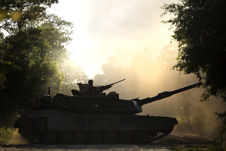 An M1A1 Abrams with Fox Company, 4th Tank Battalion, drives down a dirt road to leave Engineer Training Area 2 on Camp Lejeune, N.C., July 21, 2016. The intent was to bring the active and reserve Marines together to train in the event they deploy as one battalion in the future. (U.S. Marine Corps photo by Sgt. Matthew Callahan)