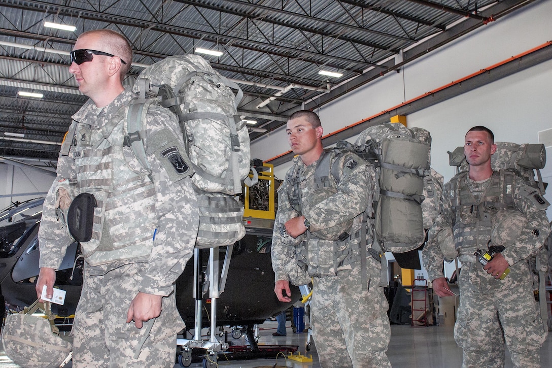 Soldiers line up for check-in at the Army Aviation Support Facility in South Burlington, Vt., July 20, 2016. The soldiers are assigned to the Vermont National Guard’s Company A, 86th Special Troops Battalion. They conducted manifest procedures before boarding CH-47 Chinook helicopters as part of their annual training. Army National Guard photo by Spc. Avery Cunningham