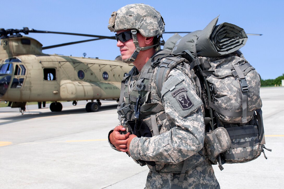 A soldier walks to a CH-47 Chinook at the Army Aviation Support Facility in South Burlington, Vt., July 20, 2016. Army National Guard photo by Spc. Avery Cunningham