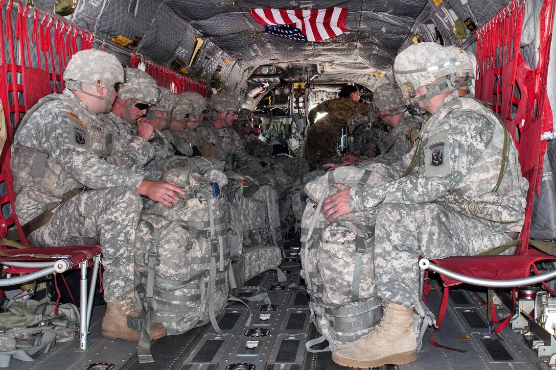 Soldiers take their seats aboard a CH-47 Chinook helicopter before taking off from the Army Aviation Support Facility in South Burlington, Vt., July 20, 2016. Army National Guard photo by Spc. Avery Cunningham