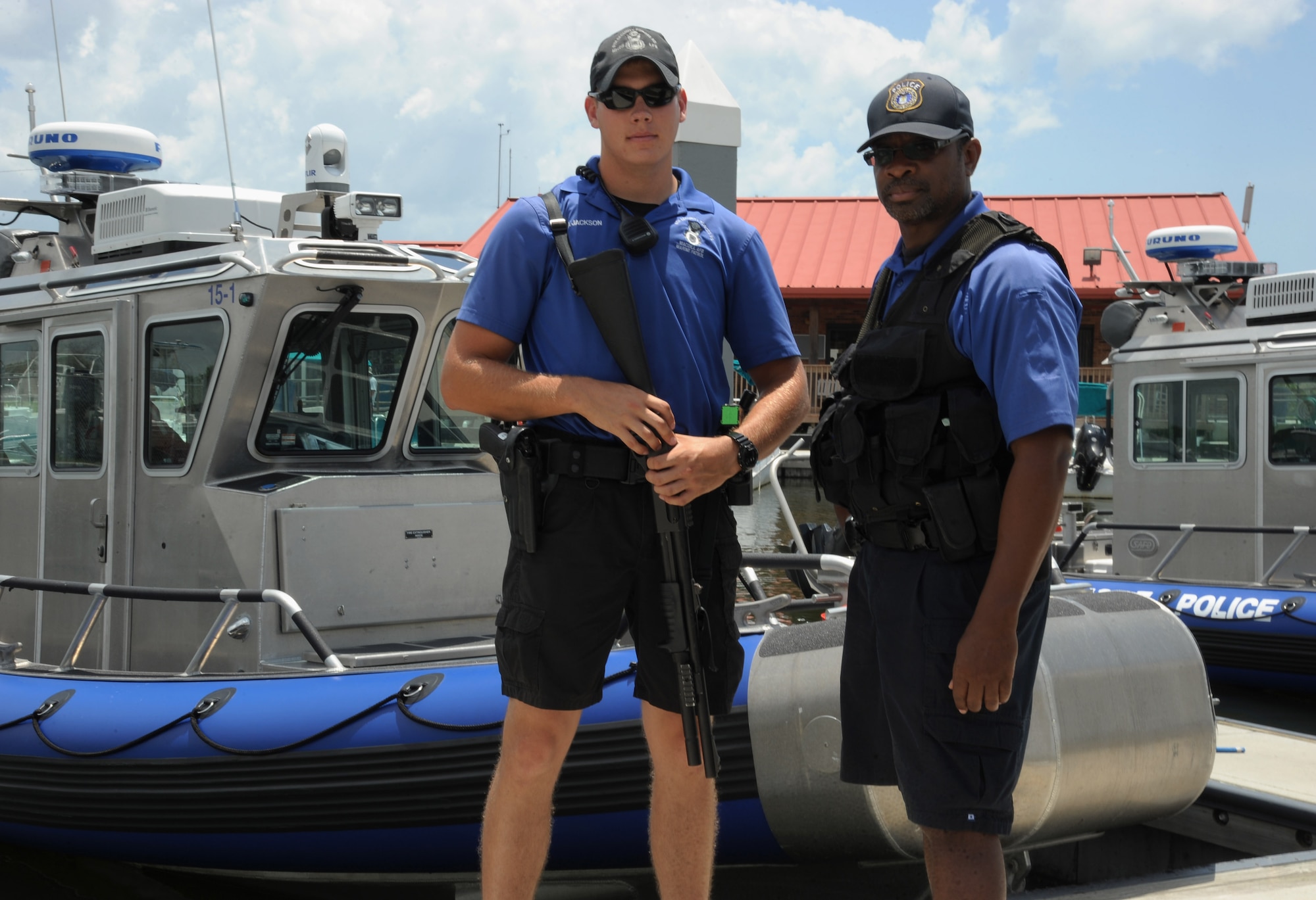 Senior Airman Craig Jackson, left, a marine patrol crewmember and Officer Dana Jette, right, a civilian marine patrol crewmember, both assigned to the 6th Security Forces Squadron (SFS) pause for a photo at the marina on MacDill Air Force Base, Fla., July 20, 2016. The 6th SFS marine patrol is the only force of its kind to operate 24/7 in the Air Force. (U.S. Air Force photo by Airman Adam R. Shanks)