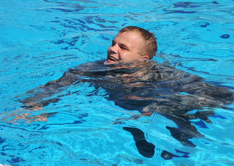 Airman 1st Class Austin Dyson, an entry controller assigned to the 6th Security Forces Squadron treads water during marine patrol tryouts at Bobby Hicks Pool in Tampa, Fla., July 21, 2016. Dyson had to keep his head above water for five minutes while in his Airman battle uniform to complete the training requirement. (U.S. Air Force photo by Airman Adam R. Shanks)