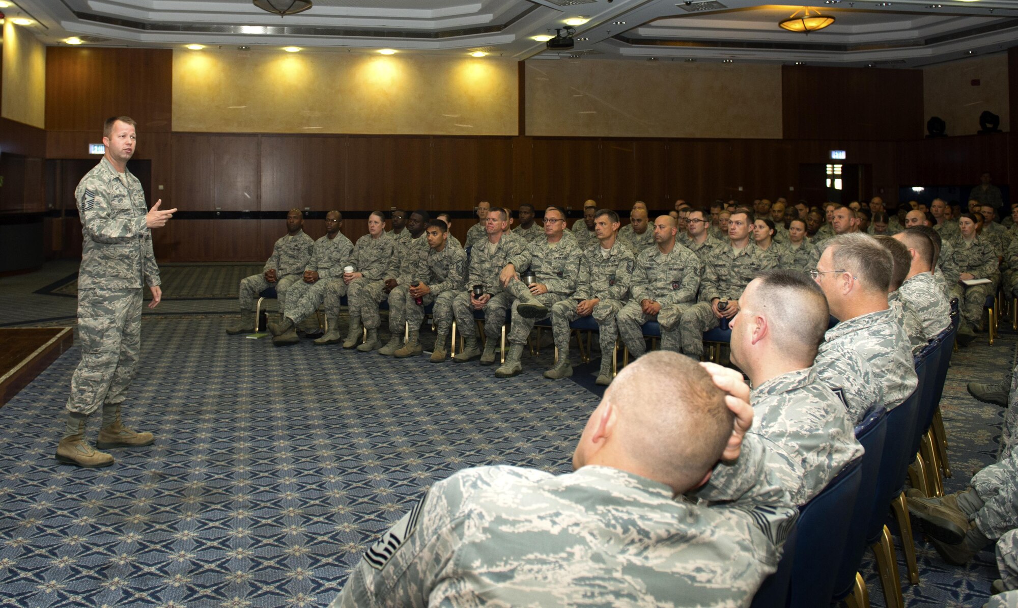 U.S. Air Force Chief Master Sgt. Edwin Ludwigsen, 52nd Fighter Wing command chief, addresses the audience at his first senior non-commissioned officer all-call at Club Eifel on Spangdahlem Air Base, Germany, July 26, 2016. The chief explained evaluation performance reviews and gave SNCO’s the chance to ask questions. (U.S. Air Force photo by Airman 1st Class Preston L. Cherry/Released)