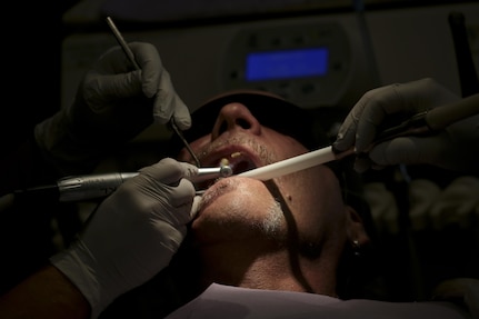 U.S. Air Force Maj. Jessica Bramlette, left, a dentist assigned to the New Jersey Air National Guard's 177th Medical Group, and Spc. Zhuhying Deng, a dental assistant from the U.S. Army Reserve's 7234th Medical Support Unit work on a patient at Homer Intermediate School, Homer, N.Y., July 20, 2016. Service members provided no cost medical, dental, optometry, and veterinary care to local residents as part of the Healthy Cortland 2016 Innovative Readiness Training mission. (U.S. Air National Guard photo by Tech. Sgt. Matt Hecht/Released)