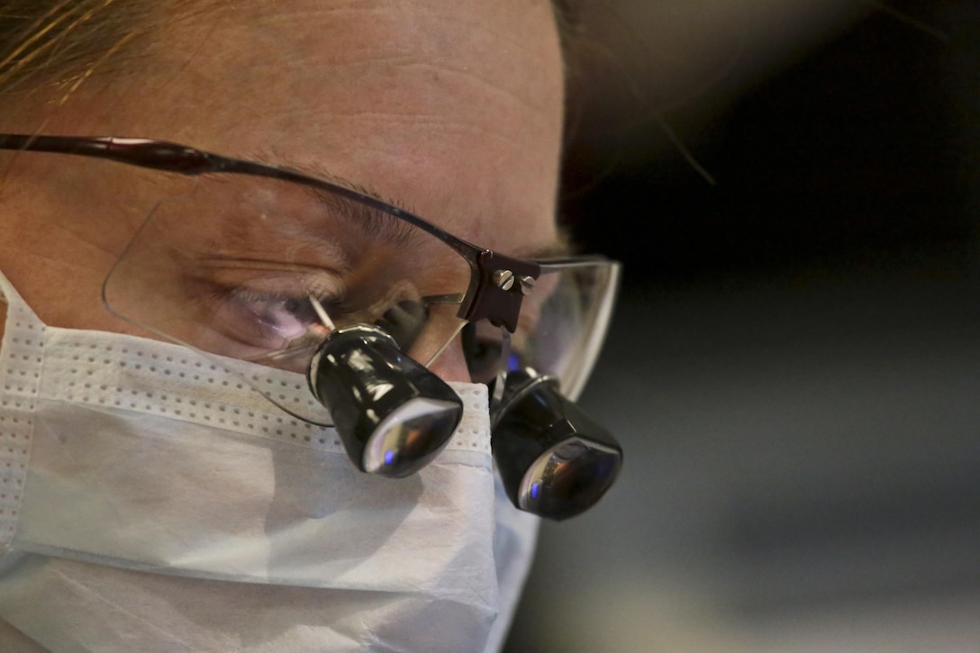 U.S. Air Force Maj. Jessica Bramlette, a dentist assigned to the New Jersey Air National Guard's 177th Medical Group, works on a patient at Homer Intermediate School, Homer, N.Y., July 20, 2016. Bramlette, along with other doctors, nurses, and specialists, provided no cost medical, dental, optometry, and veterinary care to local residents as part of the Healthy Cortland 2016 Innovative Readiness Training mission. (U.S. Air National Guard photo by Tech. Sgt. Matt Hecht/Released)