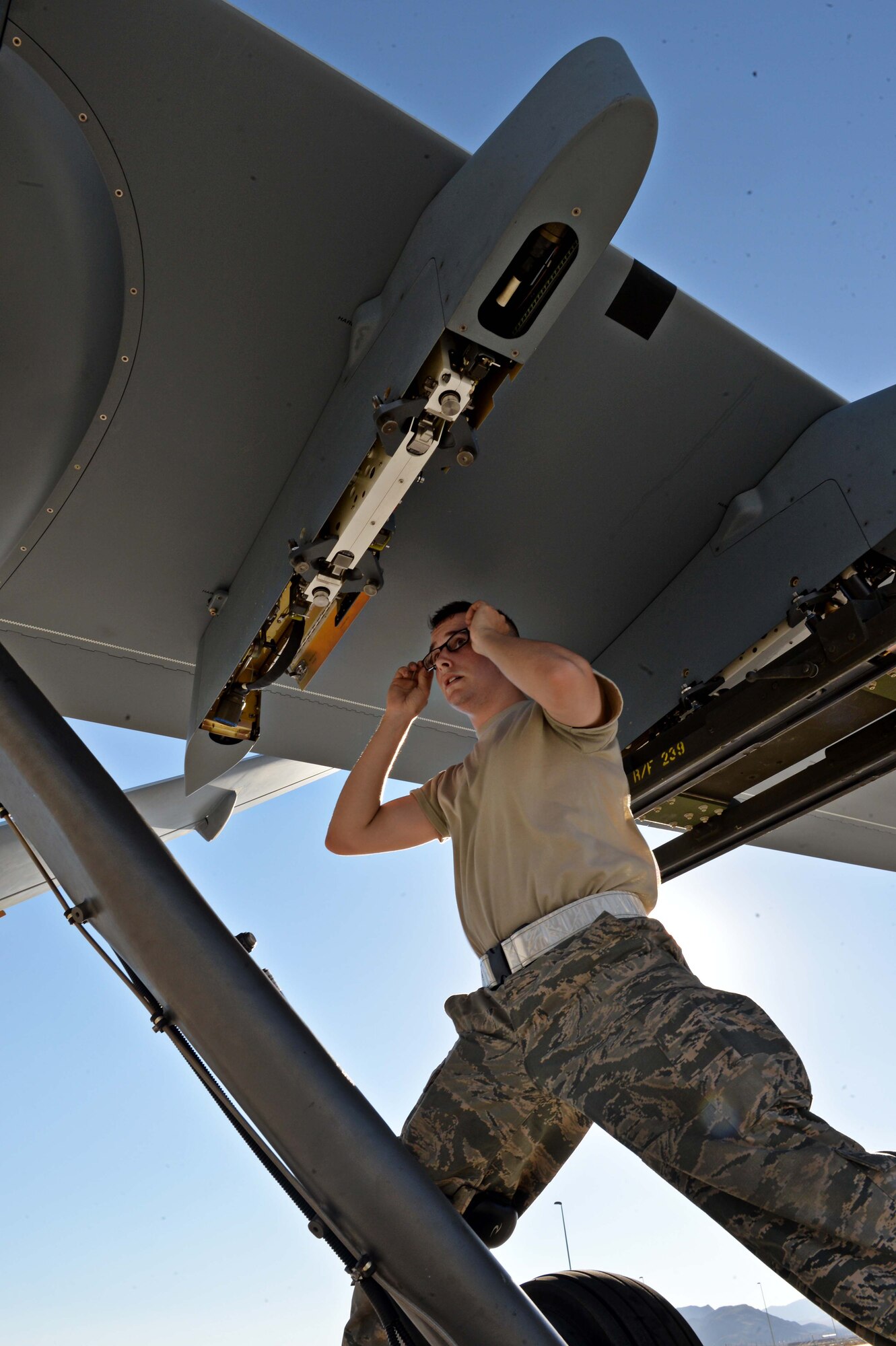 Airman 1st Class Zachary, 432nd Aircraft Maintenance Squadron weapons load crew member, inspects a munitions pylon in preparation for Red Flag 16-3 July 20, 2016, at Creech Air Force Base, Nevada. Airmen from the 432nd Wing/432nd Air Expeditionary Wing fly, maintain and support both the MQ-1 Predators and MQ-9 Reapers in Red Flag operations. (U.S. Air Force photo by Airman 1st Class Kristan Campbell/Released)