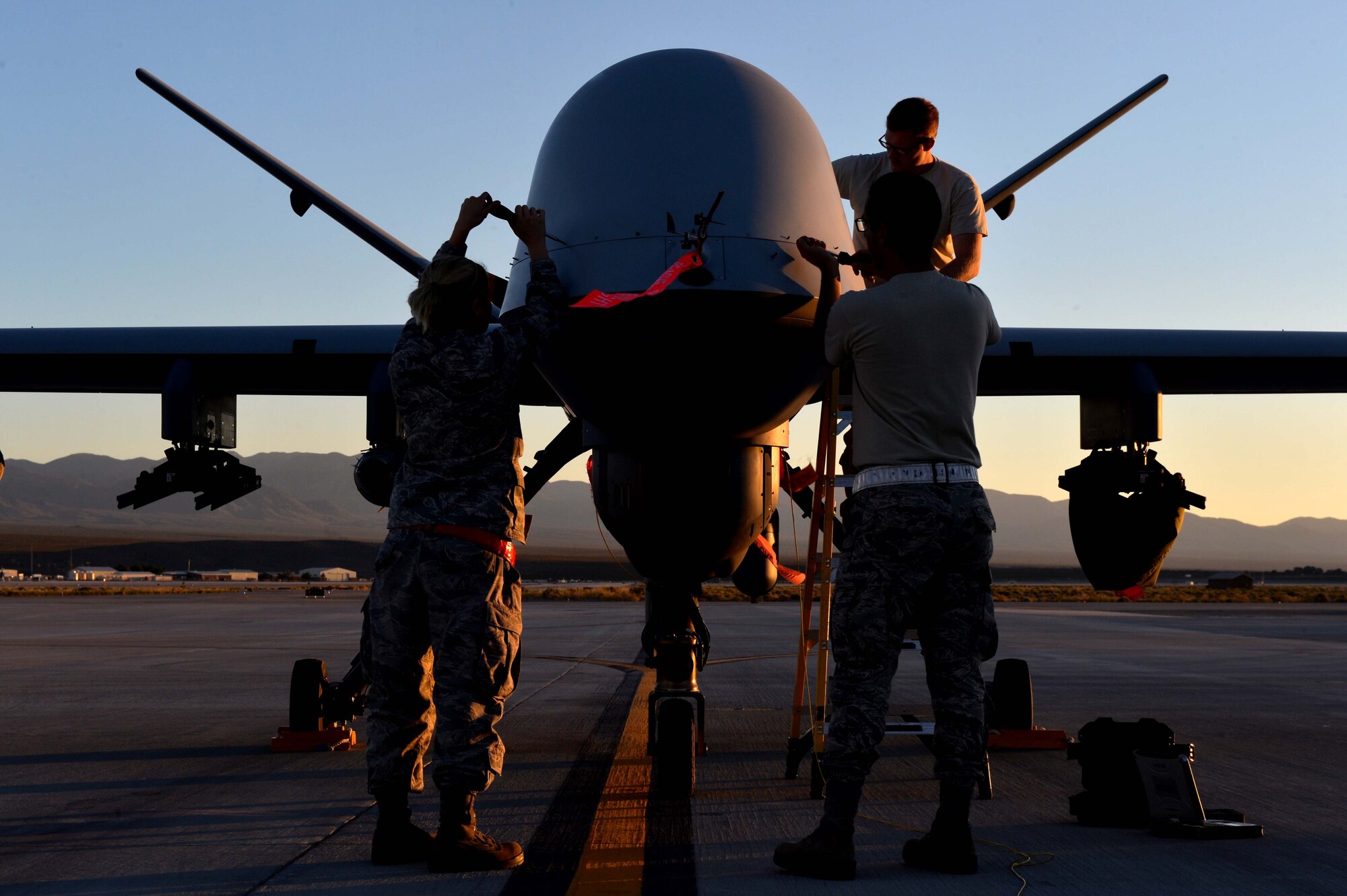 Airmen from the 432nd Wing/ 432nd Air Expeditionary Wing perform maintenance on an MQ-9 Reaper in preparation to support Red Flag 16-3 July 20, 2016, at Creech Air Force Base, Nevada. The exercise incorporates a wide range of training for air, space, and cyber systems that prepare Airmen for future operations. (U.S. Air Force photo by Airman 1st Class Kristan Campbell/Released)
