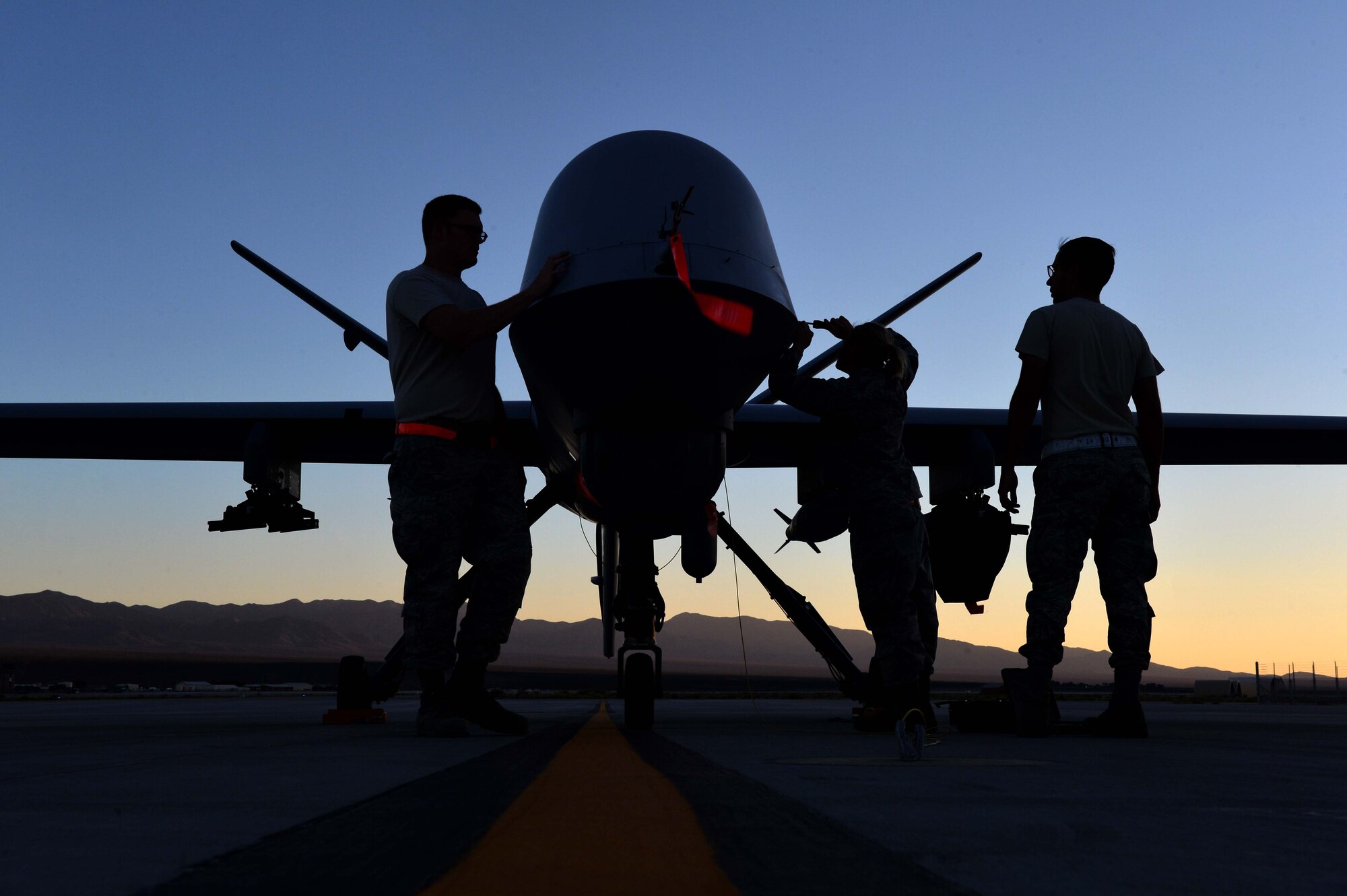 Airmen from the 432nd Aircraft Maintenance Squadron perform maintenance on an MQ-9 Reaper in preparation to support Red Flag 16-3 July 20, 2016, at Creech Air Force Base, Nevada. The exercise also incorporates aircraft platforms from U.S. military services and coalition partners in a variety of training scenarios. U.S. Air Force photo by Airman 1st Class Kristan Campbell/Released)