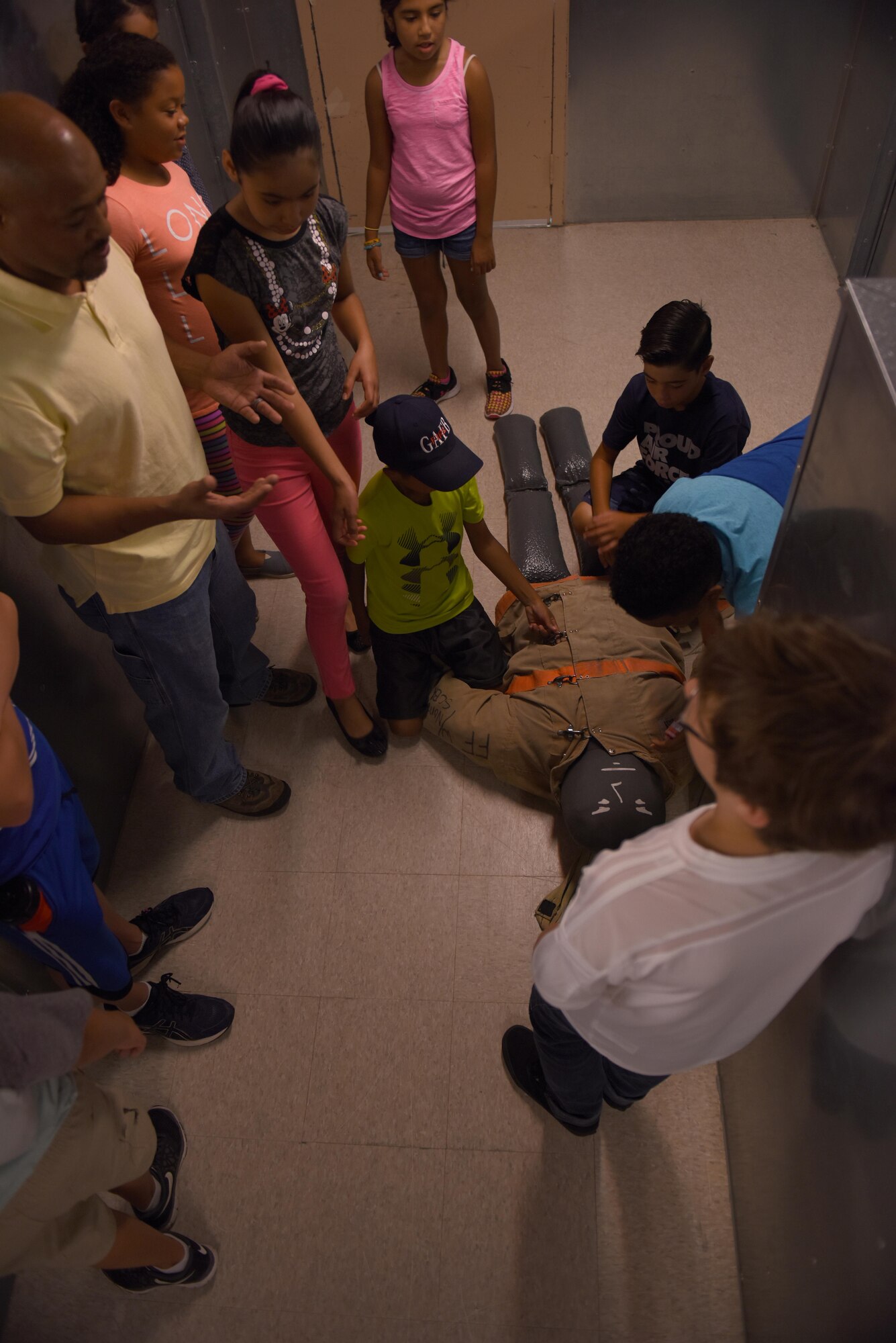 Junior Firefighter Camp Participants toured inside a training building at the Louis F. Garland Department of Defense Fire Academy, July 22, 2016. The participants learned how military firefighters train to clear rooms and rescue victims from certain types of fires. (U.S. Air Force photo by Airman 1st Class Caelynn Ferguson/Released)