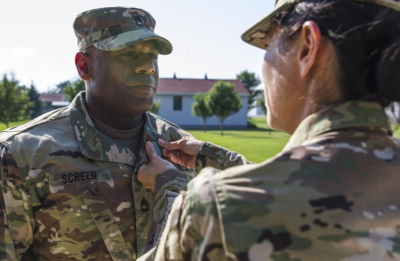 85: U.S. Army Reserve Brig. Gen. Marion Garcia, interim commanding general of the 200th Military Police Command, pins the Army Commendation Medal on Sgt. 1st Class Shawn Lee Screen, the mobilization noncommissioned officer in charge at the 11th MP Brigade, July 18 during Warrior Exercise 86-16-03 at Fort McCoy, Wisc. Screen, who lives in Temecula, Calif., saved the life of a civilian who was choking while during lunch with a contingent of MPs from Taiwan July 17 in The Dells, Wisc. (U.S. Army Photo by Sgt. 1st Class Jacob Boyer)