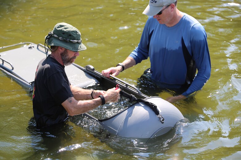 Ed Maziarski (left) and Jake Feeney of Reconnaissance and Amphibious Raids at Marine Corps Systems Command prepare a Diver Propulsion Device for testing July 18 at Lake Anna in Spotsylvania, Va. The team worked with Marine combatant divers to conduct tests of potential upgrades to the DPD to improve its speed and controllability. (U.S. Marine Corps photo by Monique Randolph)