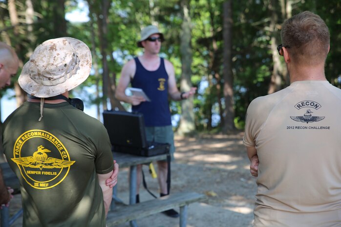 Navy Diver First Class Jason Young (center), Marine Corps Systems Command diving officer with Reconnaissance and Amphibious Raids, gives a safety briefing prior to a dive July 18 at Lake Anna in Spotsylvania, Va. The RAR team worked with several Marine combatant divers to conduct tests of potential upgrades to the Diver Propulsion Device to improve its speed and controllability. (U.S. Marine Corps photo by Monique Randolph)