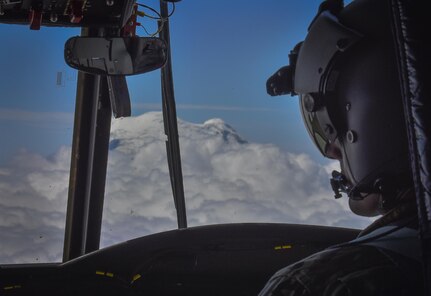 U.S. Army Reserve Chief Warrant Officer 3 Brian Pavlik, 1-214th General Support Aviation Battalion, Bravo Company, keeps a watchful eye during a flyover near Mount Rainier, Wash., onboard a CH-47 Chinook, July 22, 2016.  The 1-214th GSAB, has a unique mission which involves working with the Washington National Park  and provides support for search and rescue missions as well as fire rescue missions in the area.  (U.S. Army photo by Master Sgt. Marisol Walker/Released)