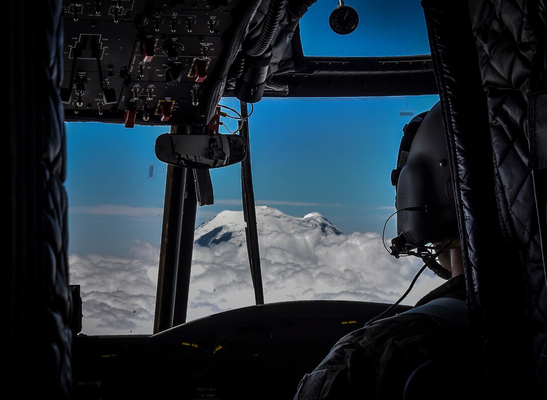 U.S. Army Reserve Chief Warrant Officer 3 Brian Pavlik, 1-214th General Support Aviation Battalion, Bravo Company, keeps a watchful eye during a flyover near Mount Rainier, Wash., onboard a CH-47 Chinook, July 22, 2016.  The 1-214th GSAB, has a unique mission which involves working with the Washington National Park  and provides support for search and rescue missions as well as fire rescue missions in the area.  (U.S. Army photo by Master Sgt. Marisol Walker/Released)