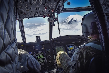 U.S. Army Reserve Chief Warrant Officer 3 Brian Pavlik, 1-214th General Support Aviation Battalion, Bravo Company, keeps a watchful eye during a flyover near Mount Rainier, Wash., onboard a CH-47 Chinook, July 22, 2016.  The 1-214th GSAB, has a unique mission which involves working with the Washington National Park  and provides support for search and rescue missions as well as fire rescue missions in the area.  (U.S. Army photo by Master Sgt. Marisol Walker/Released)