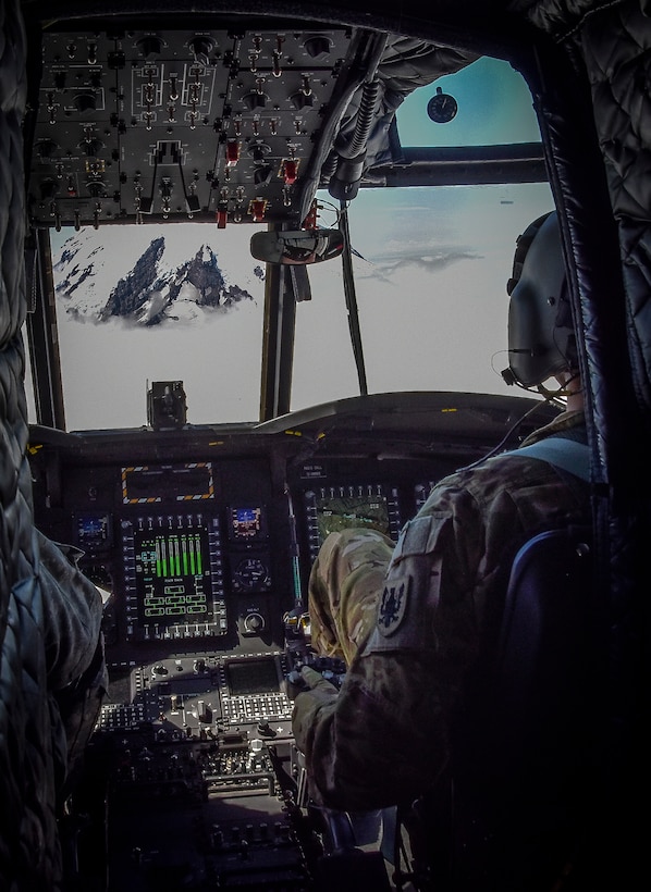 U.S. Army Reserve Chief Warrant Officer 3 Brian Pavlik, 1-214th General Support Aviation Battalion, Bravo Company, keeps a watchful eye during a flyover near Mount Rainier, Wash., onboard a CH-47 Chinook, July 22, 2016.  The 1-214th GSAB, has a unique mission which involves working with the Washington National Park  and provides support for search and rescue missions as well as fire rescue missions in the area.  (U.S. Army photo by Master Sgt. Marisol Walker/Released)