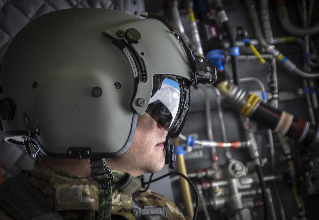 U.S. Army Reserve Sgt. Dan Glenn, 1-214th General Support Aviation Battalion, Bravo Company, enjoys the view during a flyover near Mount Rainier, Wash., onboard a CH-47 Chinook, July 22, 2016.  The 1-214th GSAB, has a unique mission which involves working with the Washington National Park  and provides support for search and rescue missions as well as fire rescue missions in the area. (U.S. Army photo by Master Sgt. Marisol Walker/Released)