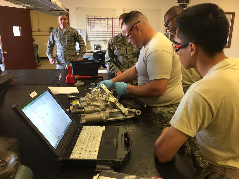 Hydraulics maintainers Tech. Sgt. Kevin Gray (from left), Airman 1st Class Garrett Byers, Airman Jonathan Edwards, and Airman Aaron Castro-Zulueta, all of the 56th Component Maintenance Squadron, observe as Airman First Class Steven Lohman completes repairs on an A-10 elevator actuator. (U.S. Air Force photo/Brian Ward)