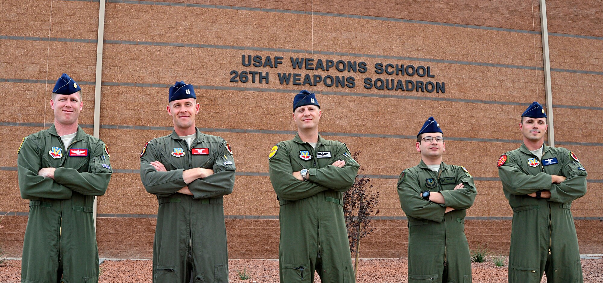 Airmen from the 432nd Wing/432nd Air Expeditionary Wing pose with their instructor, Capt. Craig, 26th Weapon Squadron MQ-9 Pilot (center), after graduating from the U.S. Air Force’s first-ever Electronic Combat Officers course. The course focuses on training aircrews of MQ-1 Predator and MQ-9 Reaper aircraft to mitigate potential signal interruptions thus reducing the potential risks to RPAs. (U.S. Air Force photo by Tech. Sgt. Nadine Barclay)