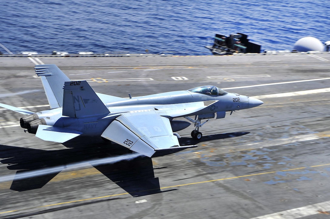 An F/A-18F Super Hornet performs a touch-and-go landing on the flight deck of the aircraft carrier USS George Washington in the Atlantic Ocean, July 18, 2016. The Super Hornet is assigned to Strike Fighter Squadron 122. The George Washington is underway conducting carrier qualifications in the Atlantic Ocean. Navy photo by Seaman Apprentice Krystofer N. Belknap