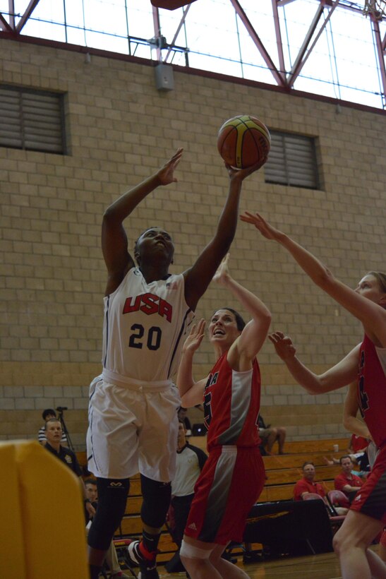 U.S. Seaman Shaniqua "Mo" Bennett goes in for a layup against Canadian defenders during the first day of the World Military Women's Basketball Championship at Camp Pendleton, Calif., July 25, 2016. Bennett scored 11 points in the game and USA beat Canada 82-25.
