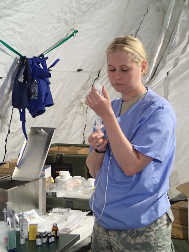 Sgt. Courtney Kreft, a veterinary technician from the 422nd Medical Detachment Veterinary Services out of Rockville, Md., measures out medication prior to surgery in the veterinary section during Greater Chenango Cares, July 23, 2016.  Greater Chenango Cares is one of the Innovative Readiness Training events which provides real-world training in a joint civil-military environment while delivering world-class medical care to the people of Chenango County, N.Y., from July 15-24.