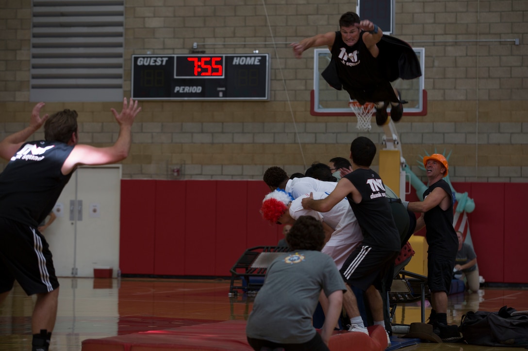 A member of the Dunk Squad leaps over a group of volunteers during the opening ceremony for the 2016 Conseil International Du Sport Militaire (CISM) World Military Women’s Basketball Championship July 25 at Camp Pendleton, California. Camp Pendleton is hosting the CISM World Military Women’s Basketball Championship July 25 through July 29 to promote fitness, sportsmanship among military athletes, and a broader understanding of the international community.   (U.S. Marine Corps photo by Sgt. Abbey Perria)